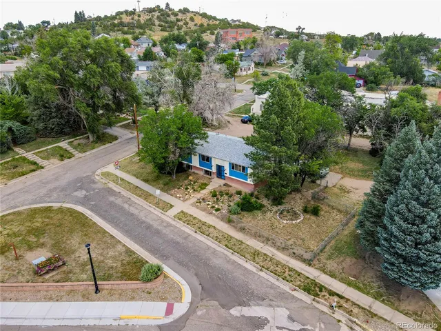 an aerial view of a house with a yard
