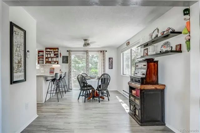 a view of a dining room with furniture and wooden floor
