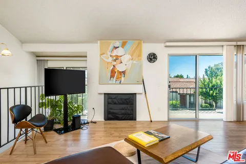 a living room with furniture rug and wooden floor