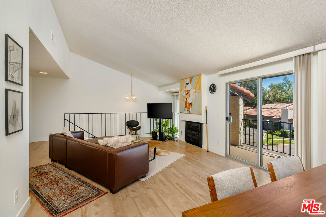 19547 Rinaldi Street, Unit 30 Porter Ranch, CA 91326 - Photo 16 of 33 a living room with furniture and a fireplace