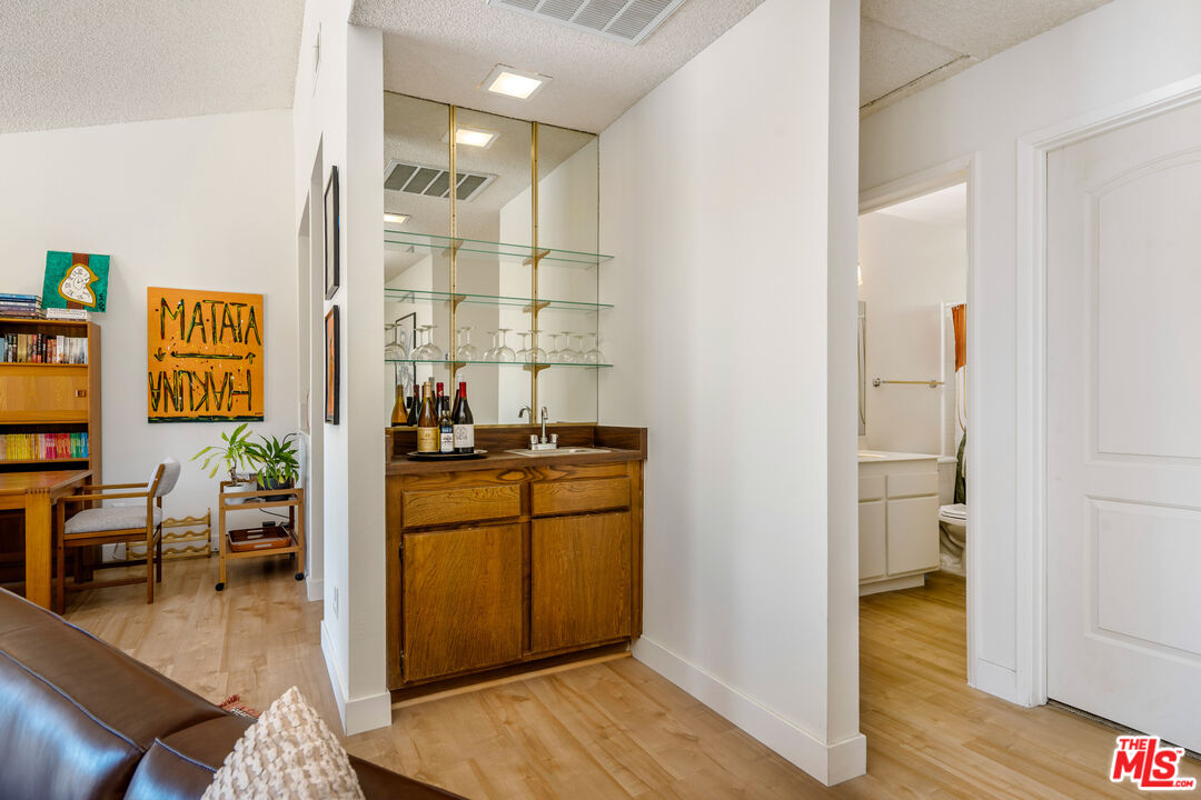 19547 Rinaldi Street, Unit 30 Porter Ranch, CA 91326 - Photo 17 of 33 a room with wooden floor and furniture