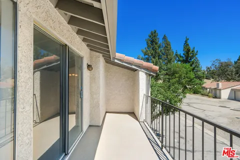 a view of a balcony with a potted plants