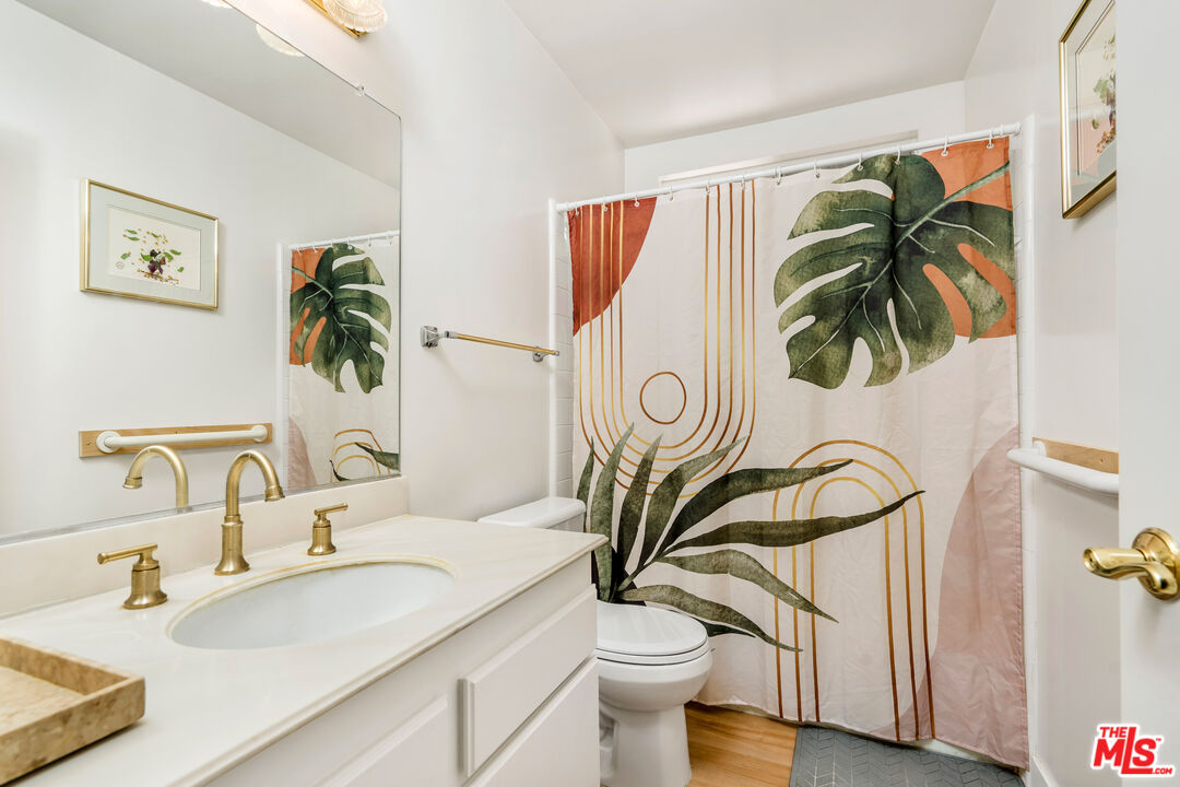 19547 Rinaldi Street, Unit 30 Porter Ranch, CA 91326 - Photo 25 of 33 a bathroom with a sink a mirror and a toilet