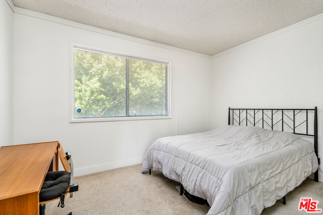 19547 Rinaldi Street, Unit 30 Porter Ranch, CA 91326 - Photo 26 of 33 a bedroom with a bed and a window