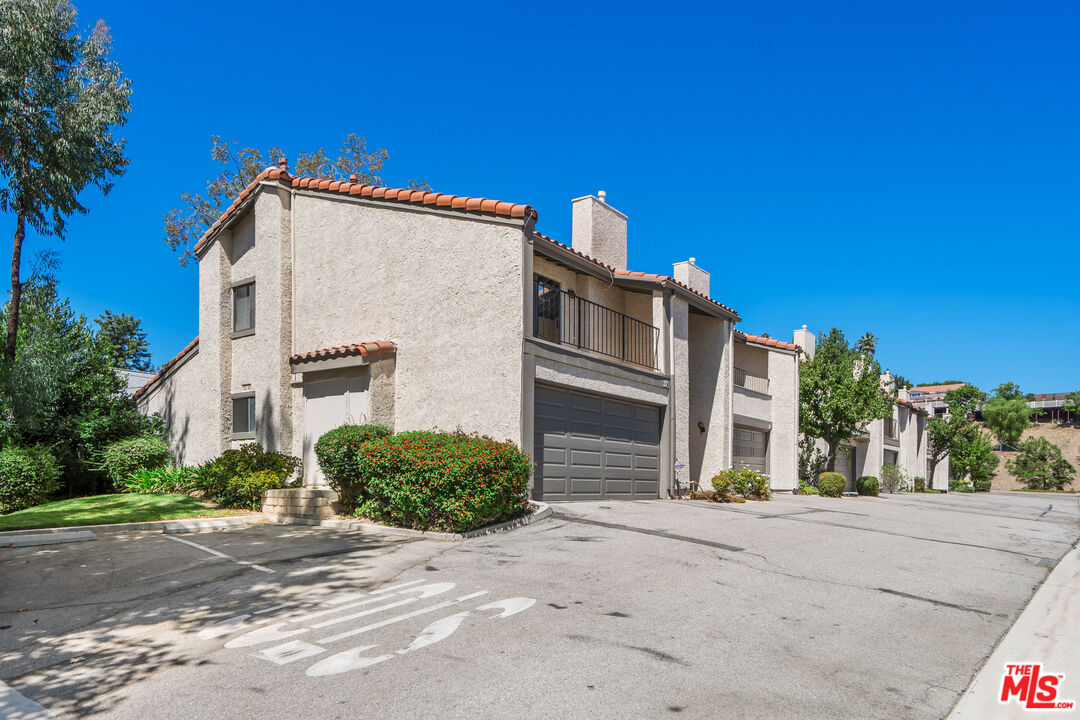 19547 Rinaldi Street, Unit 30 Porter Ranch, CA 91326 - Photo 29 of 33 a view of a house with a street