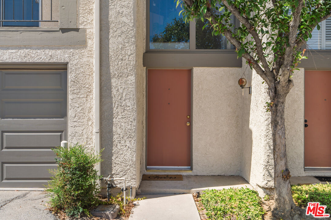 19547 Rinaldi Street, Unit 30 Porter Ranch, CA 91326 - Photo 3 of 33 a front view of a house