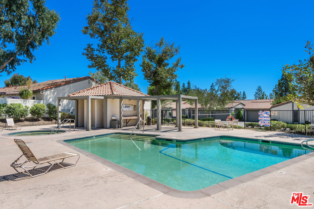 19547 Rinaldi Street, Unit 30 Porter Ranch, CA 91326 - Photo 31 of 33 a view of a house with swimming pool and sitting area