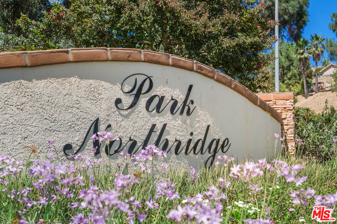 19547 Rinaldi Street, Unit 30 Porter Ranch, CA 91326 - Photo 33 of 33 a view of sign board with flower around