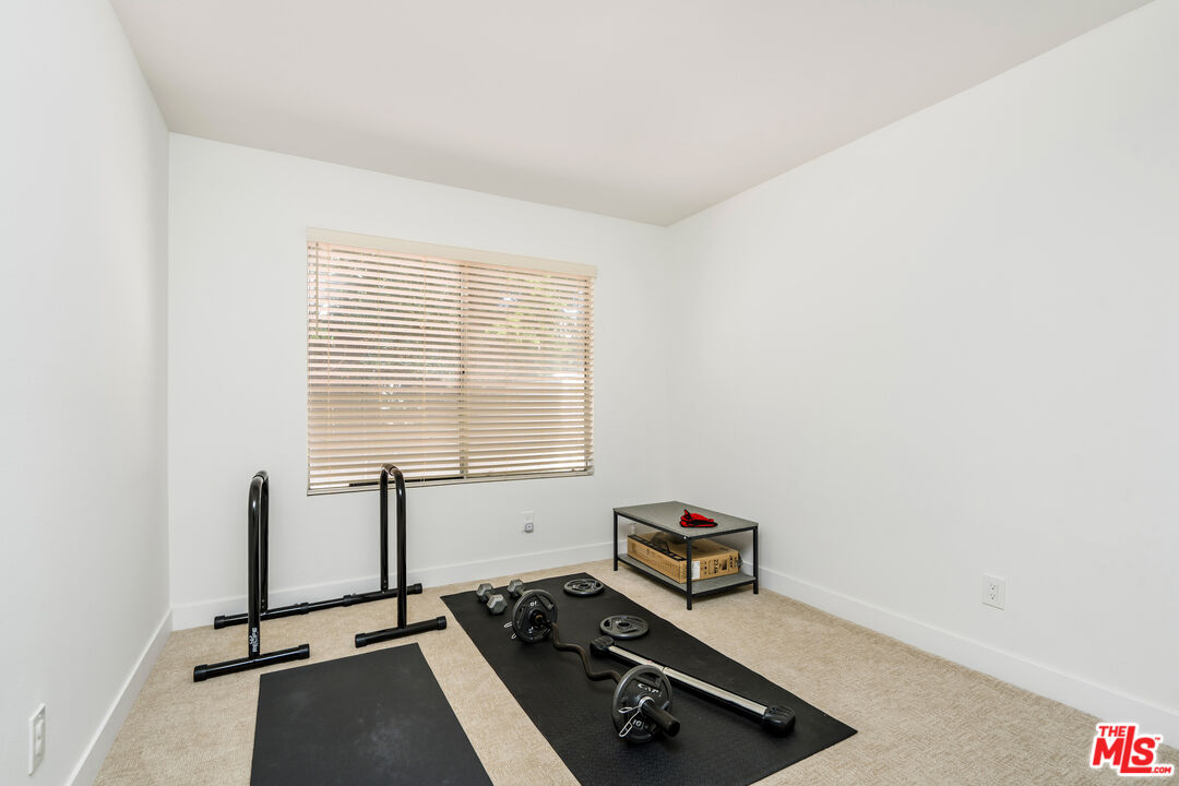 19547 Rinaldi Street, Unit 30 Porter Ranch, CA 91326 - Photo 8 of 33 a room with gym equipment and a window