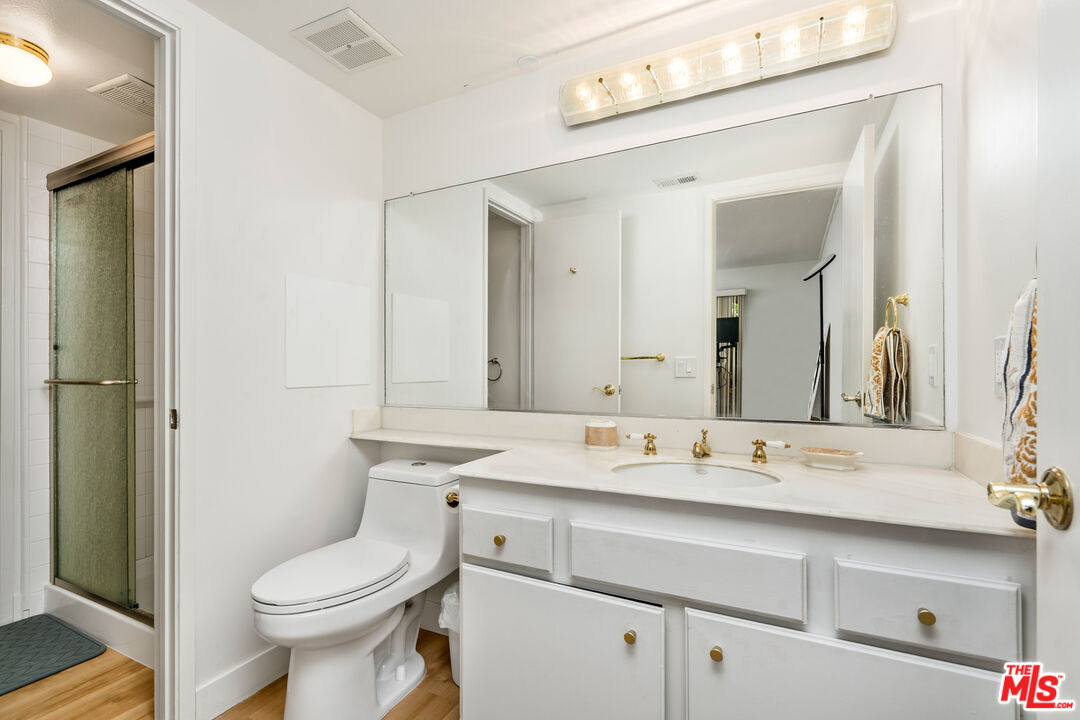 19547 Rinaldi Street, Unit 30 Porter Ranch, CA 91326 - Photo 10 of 33 a bathroom with a toilet sink and mirror