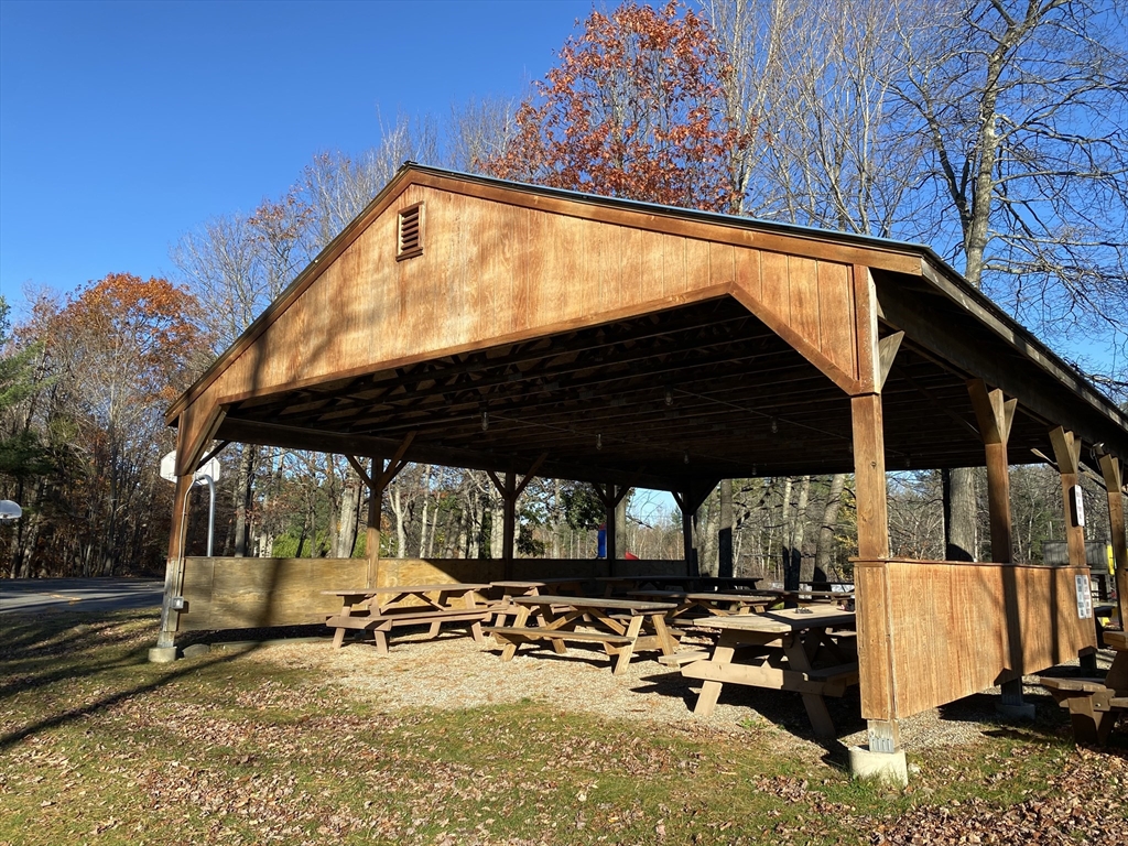 139 Taylor Brook Road Heath, MA 01346 - Photo 8 of 11 a view of a patio with a table and chairs under an umbrella with a small yard