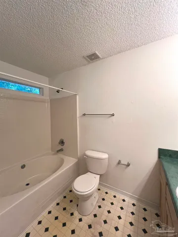 a bathroom with a bathtub and toilet