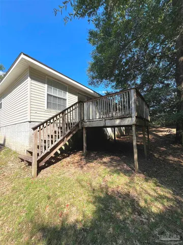 a view of a chair and table in the backyard