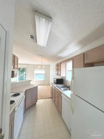 a kitchen with stainless steel appliances a refrigerator sink and cabinets