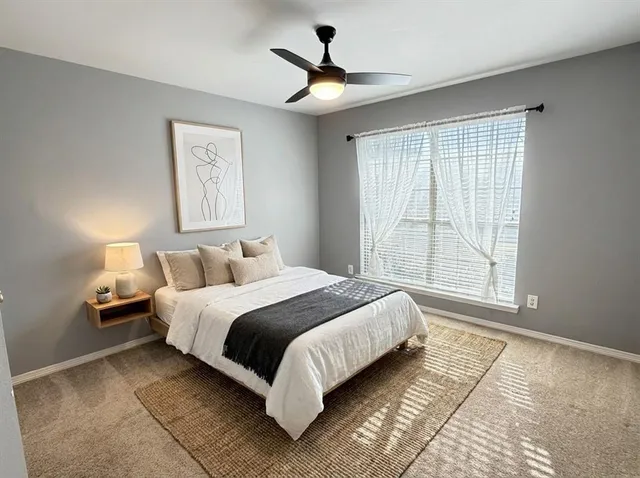 a bedroom with bed and a window