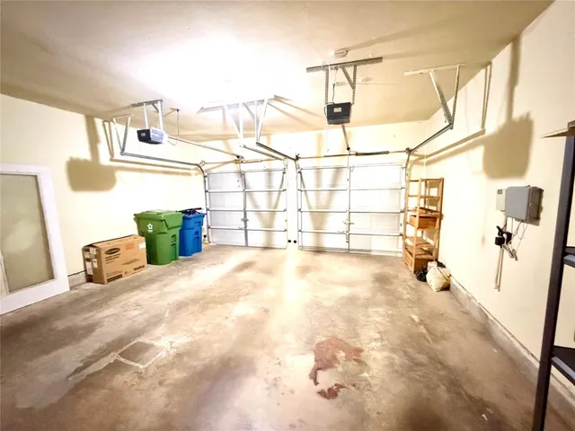 a view of a bedroom with a bed and wooden floor