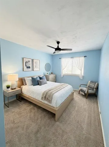 a bed room with a bed and a chair