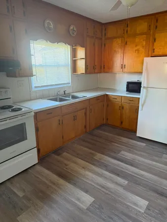a kitchen with wooden cabinets and a sink