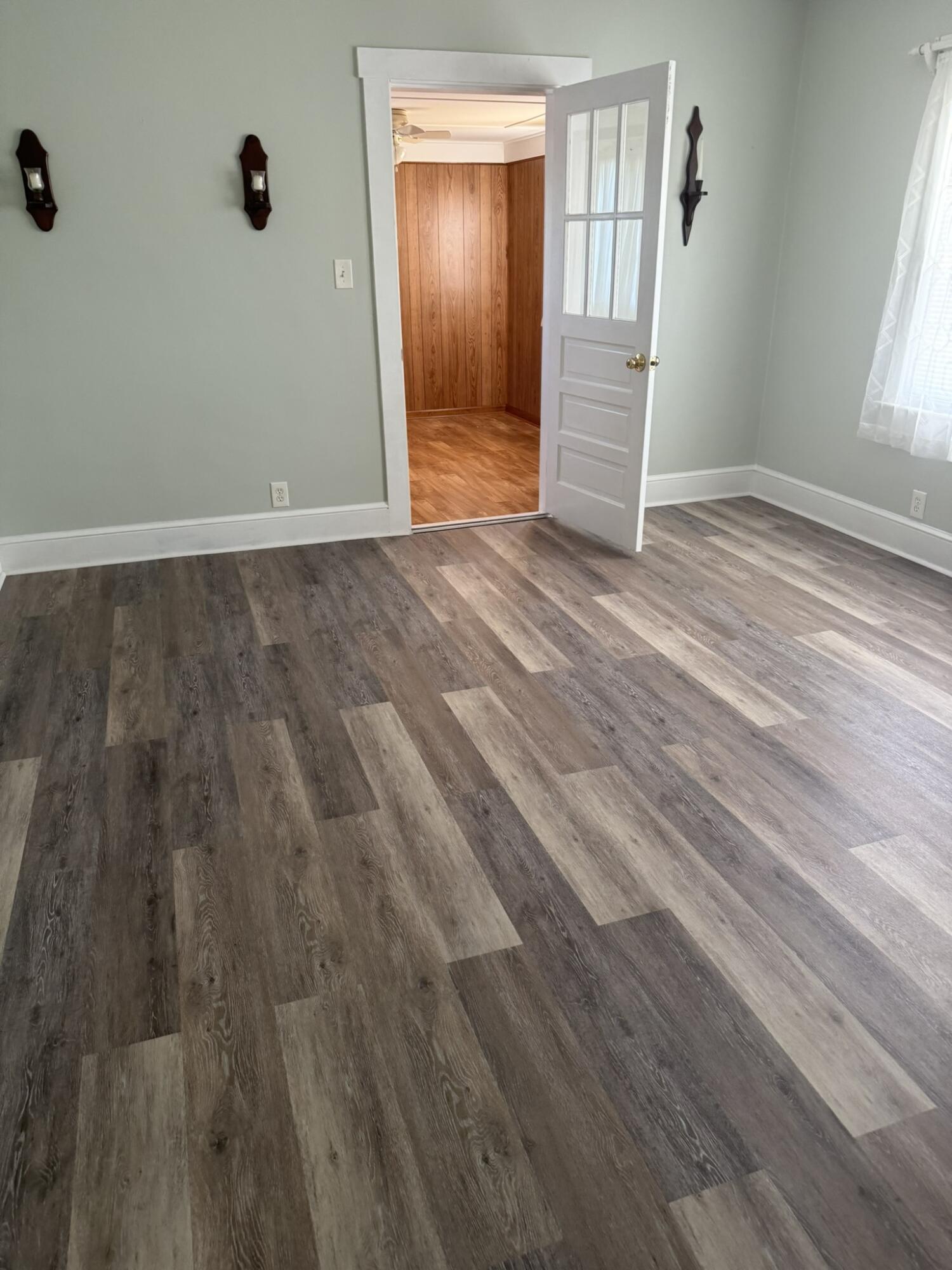 1081 East Gretna Road Gretna, VA 24557 - Photo 17 of 40 an empty room with wooden floor and windows