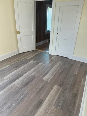 an empty room with wooden floor