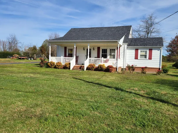 a front view of a house with a garden and porch