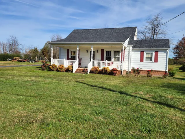 a front view of a house with a garden and porch