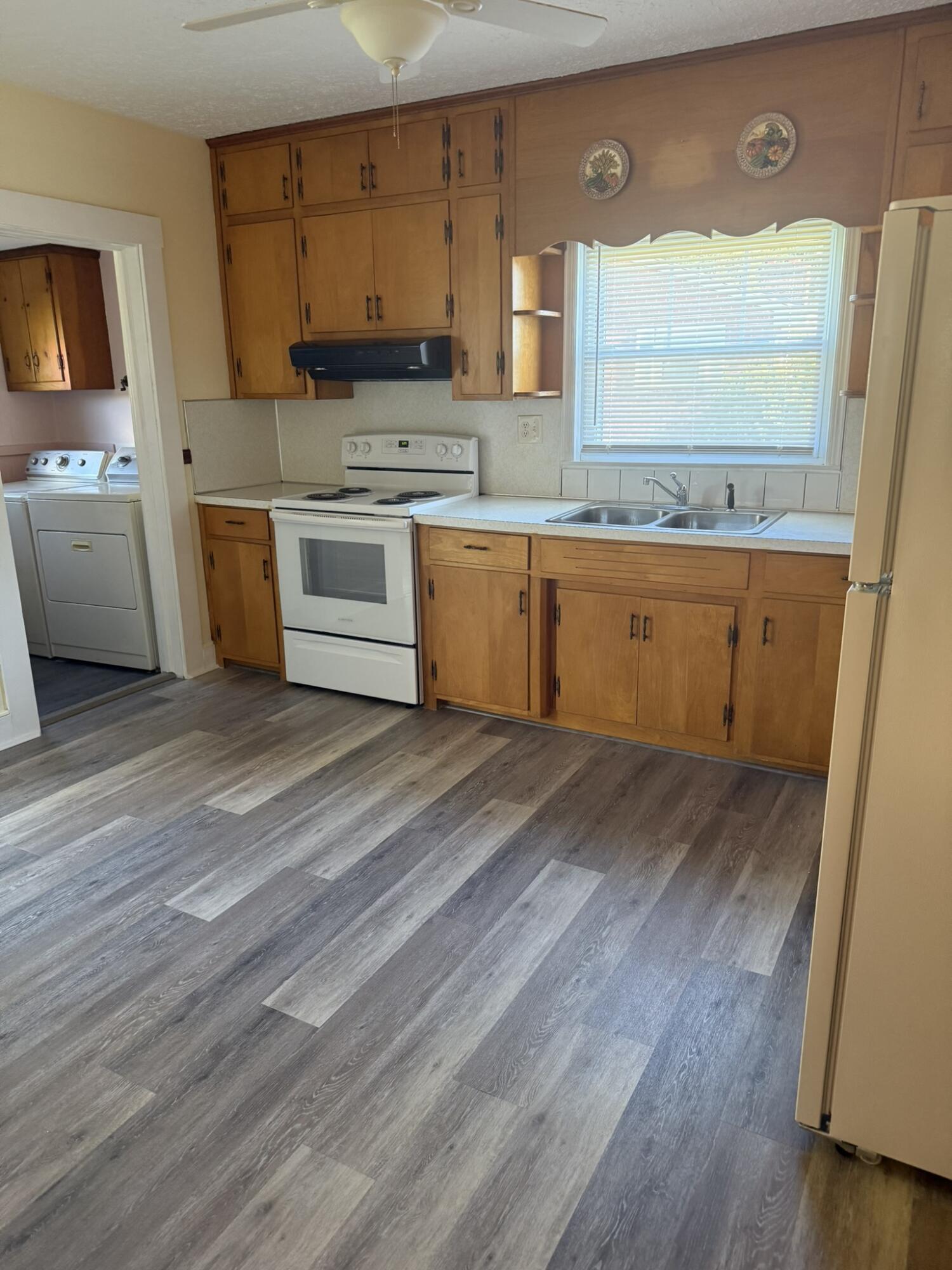 1081 East Gretna Road Gretna, VA 24557 - Photo 22 of 40 a view of a kitchen with a sink dishwasher stove and wooden floor