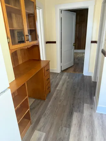 a room with wooden floor and windows