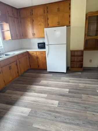 a kitchen with cabinets and white appliances
