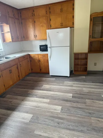 a kitchen with cabinets and white appliances