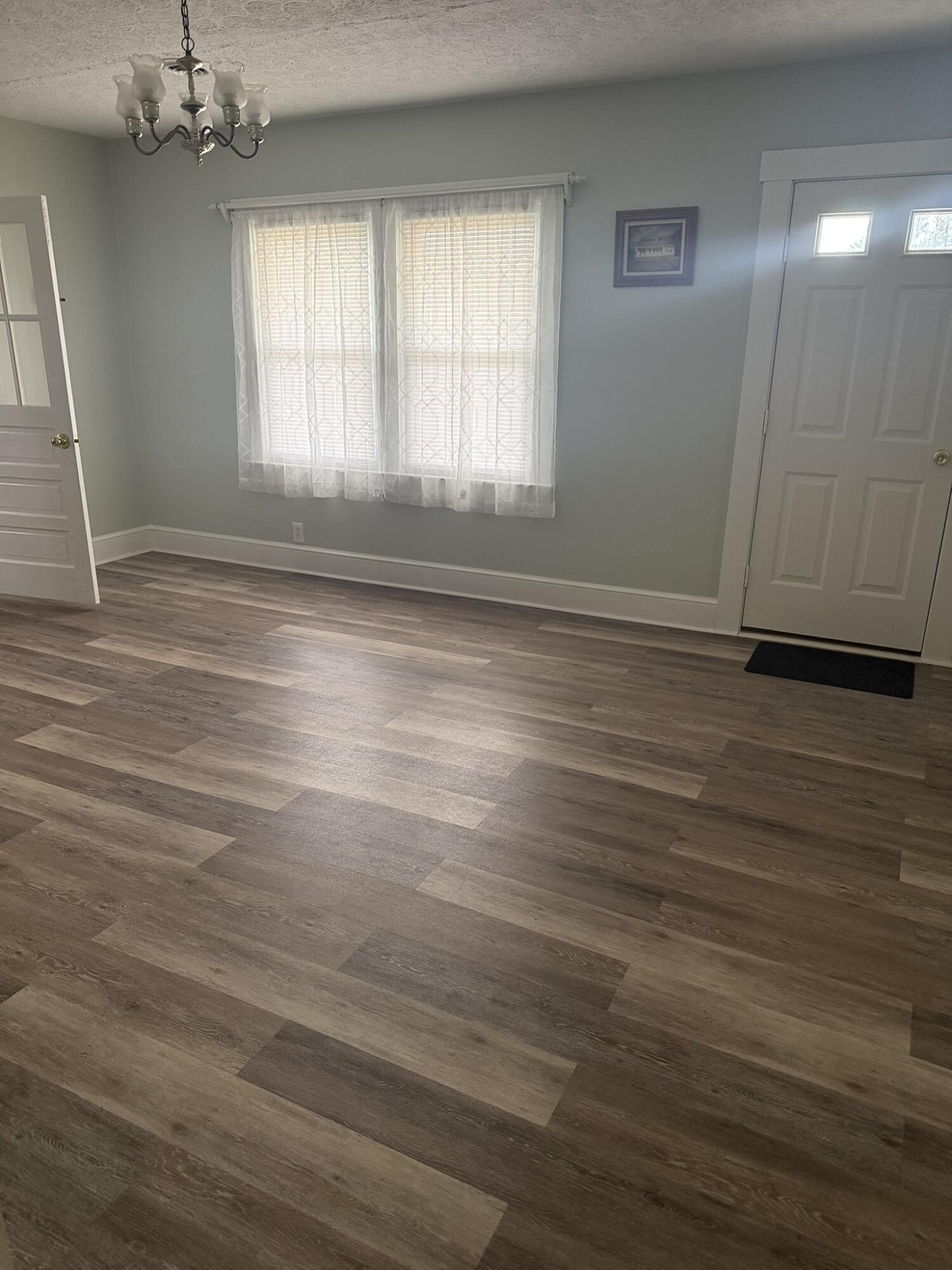 1081 East Gretna Road Gretna, VA 24557 - Photo 26 of 40 an empty room with wooden floor and windows