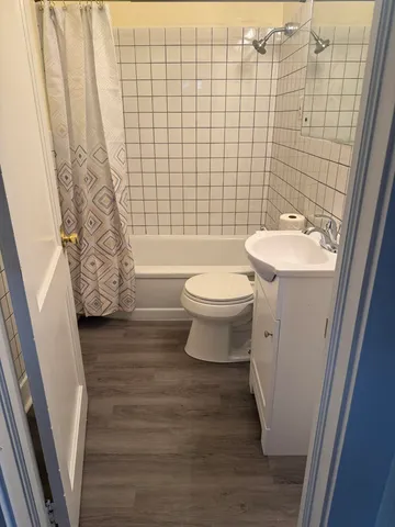 a bathroom with a toilet and shower