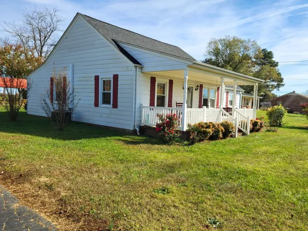 a front view of house with yard and green space