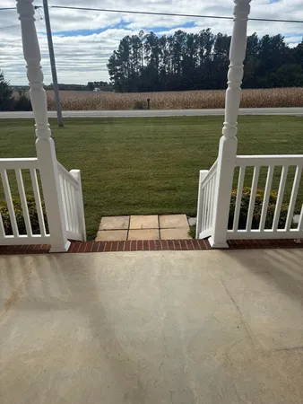 a view of wooden floor and lake from a chair