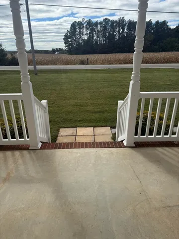 a view of wooden floor and lake from a chair