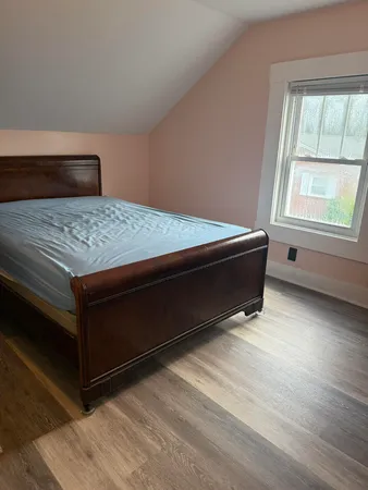 a bedroom with a bed and window