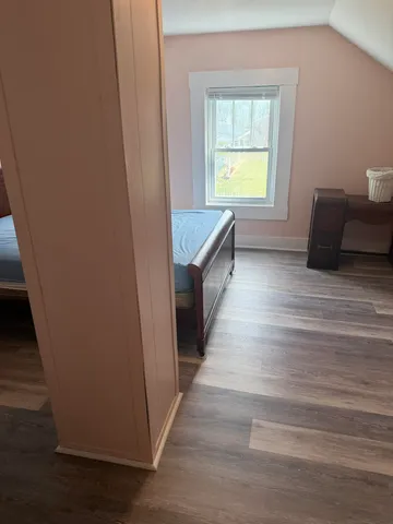 a view of entryway and hall with wooden floor