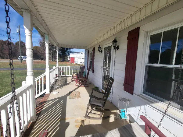 a view of a chairs and table in patio with a barbeque