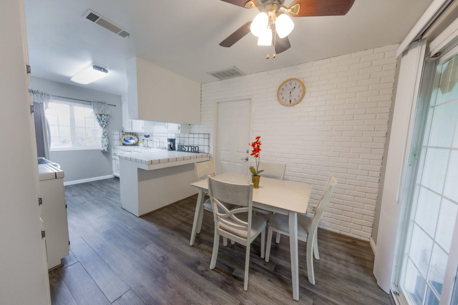 2952 Tahoe Drive Merced, CA 95340 - Photo 19 of 70 dining room with dark wood-type flooring, a ceiling fan, and brick wall