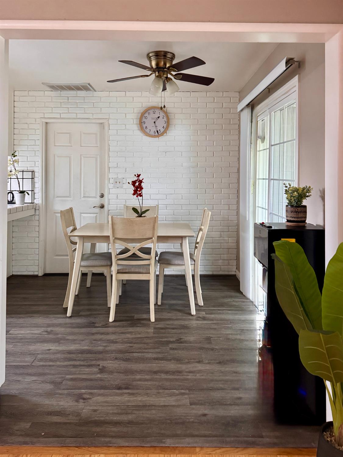 2952 Tahoe Drive Merced, CA 95340 - Photo 21 of 70 dining room featuring dark wood-type flooring, a ceiling fan, and brick wall