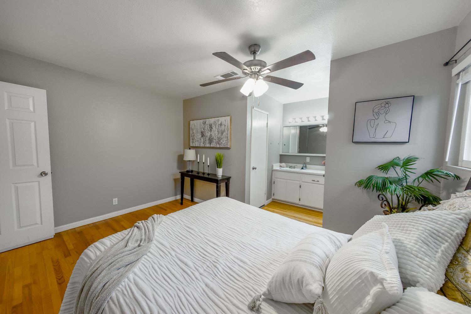 2952 Tahoe Drive Merced, CA 95340 - Photo 27 of 70 bedroom with light wood-type flooring, a ceiling fan, and ensuite bath