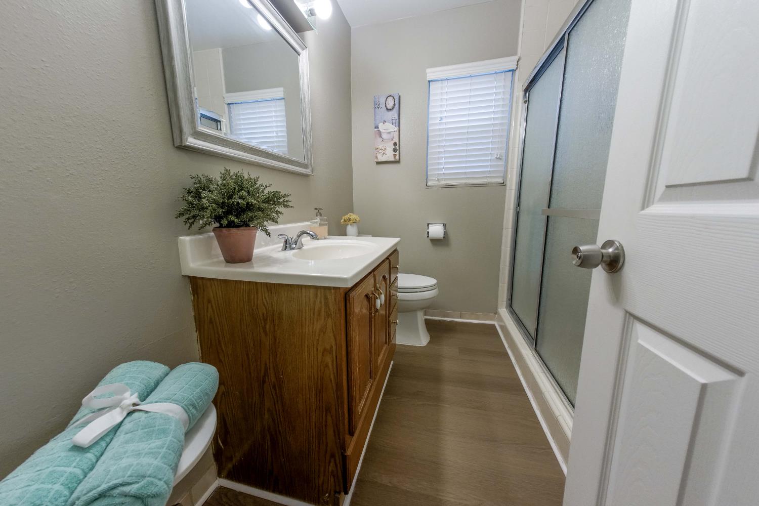 2952 Tahoe Drive Merced, CA 95340 - Photo 36 of 70 full bath with a shower stall, vanity, and dark wood-style floors