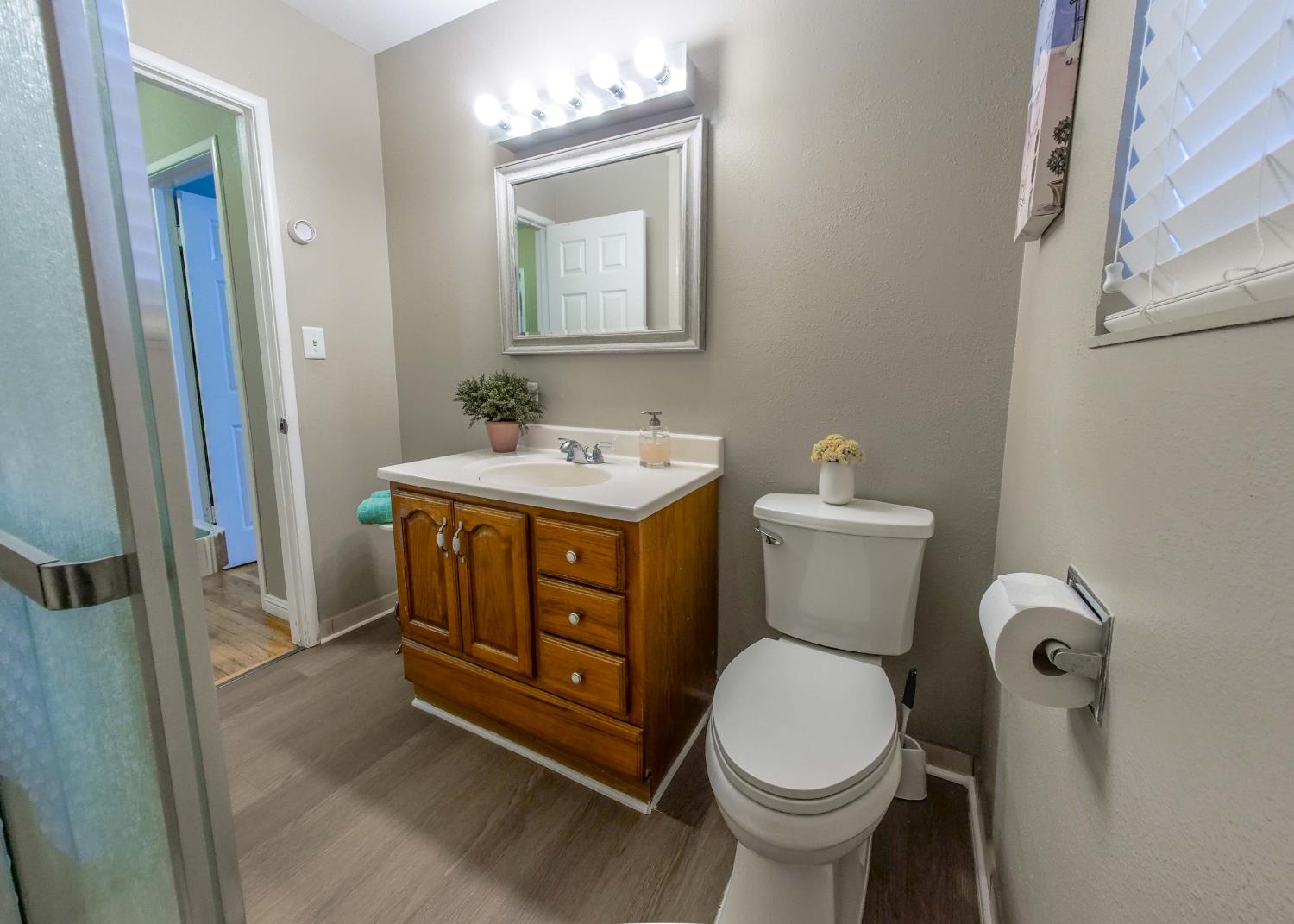 2952 Tahoe Drive Merced, CA 95340 - Photo 37 of 70 bathroom with vanity, dark wood finished floors, and a textured wall