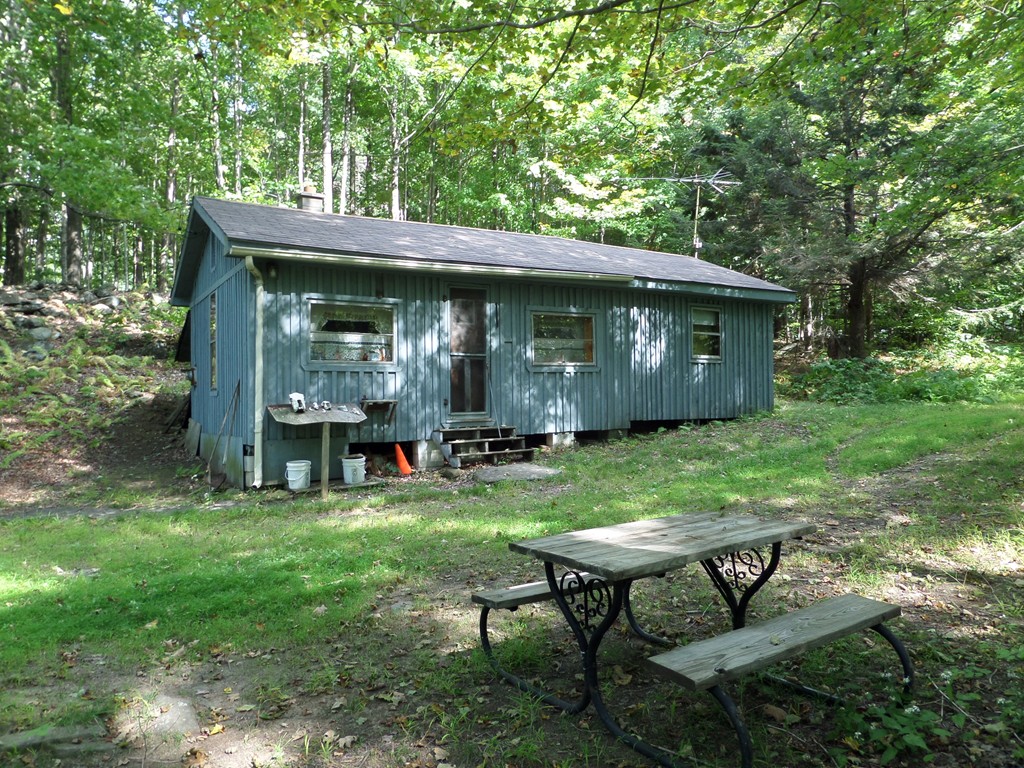 319 Harvey Road Worthington, MA 01098 - Photo 2 of 19 a view of a house with backyard sitting area and garden