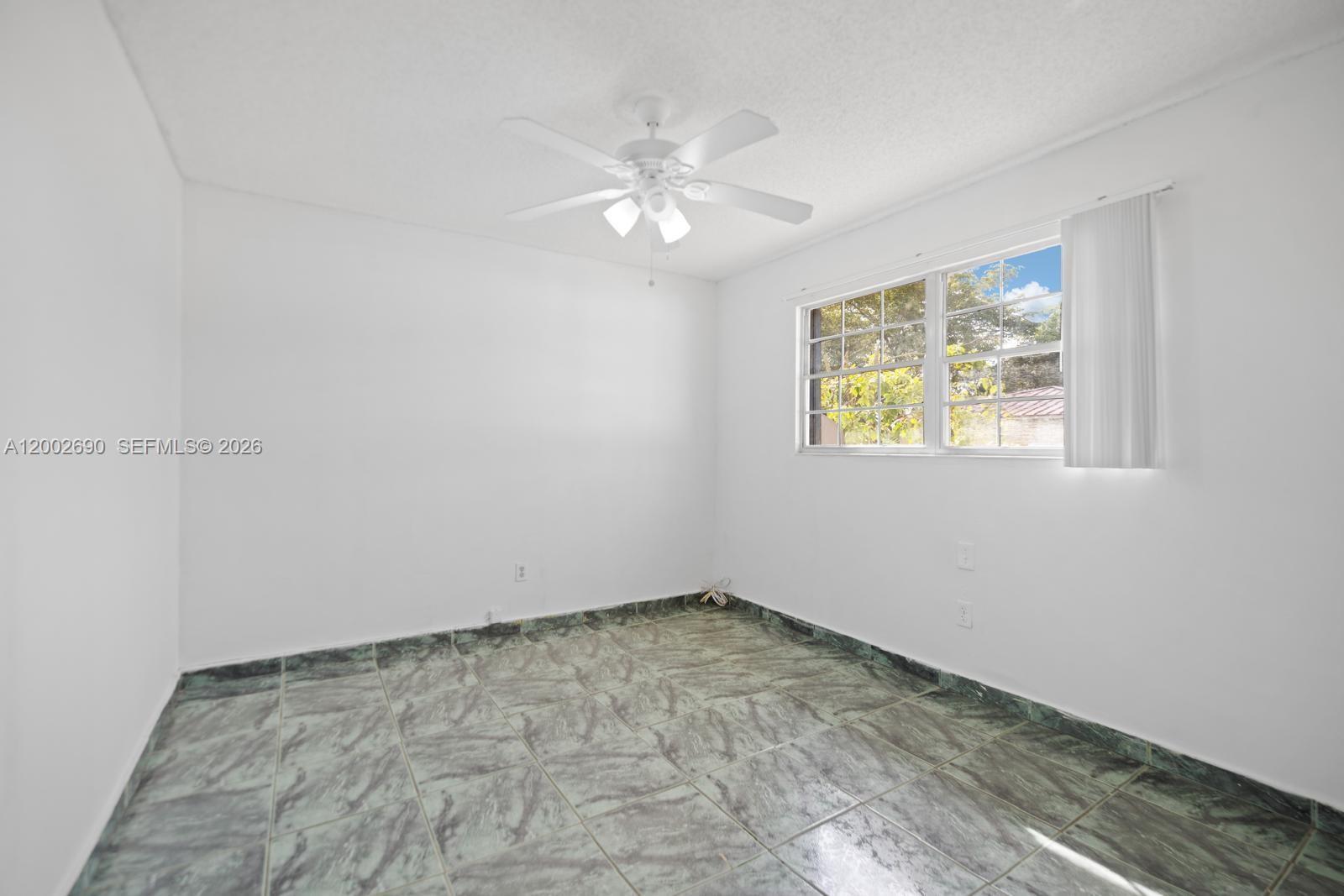 10726 Southwest 147th Court Miami, FL 33196 - Photo 12 of 23 a view of an empty room with a window