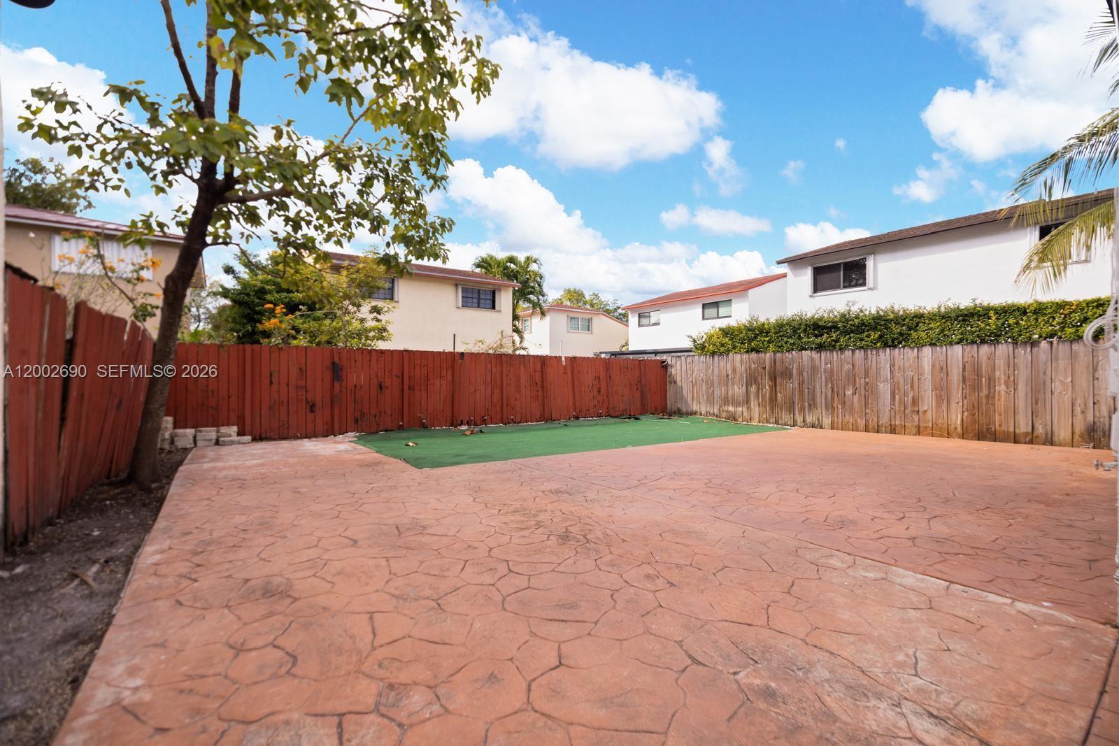 10726 Southwest 147th Court Miami, FL 33196 - Photo 19 of 23 a view of a back yard with wooden fence