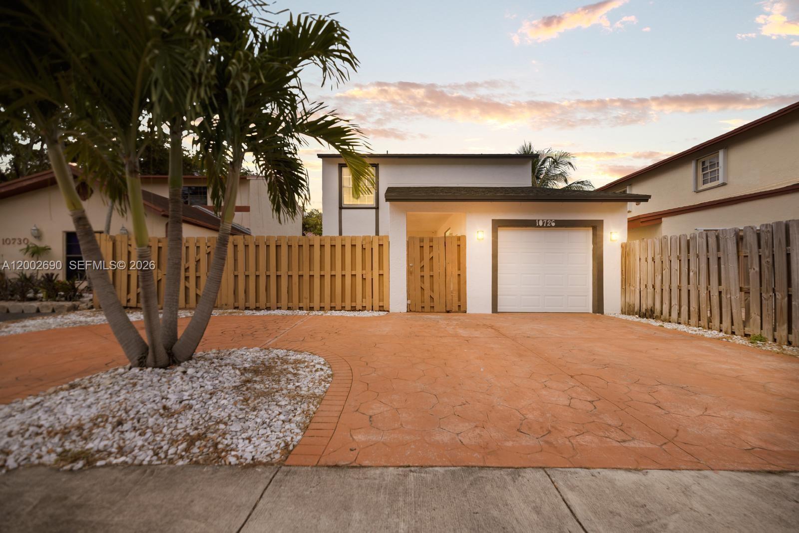 10726 Southwest 147th Court Miami, FL 33196 - Photo 2 of 23 a front view of a house with a garage
