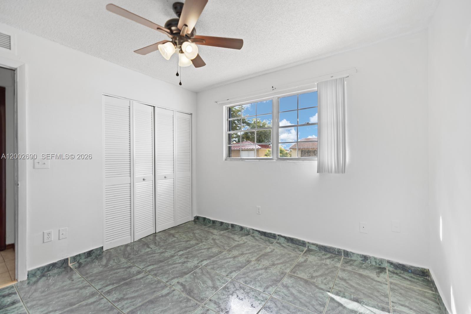 10726 Southwest 147th Court Miami, FL 33196 - Photo 9 of 23 a view of a livingroom with a ceiling fan and window