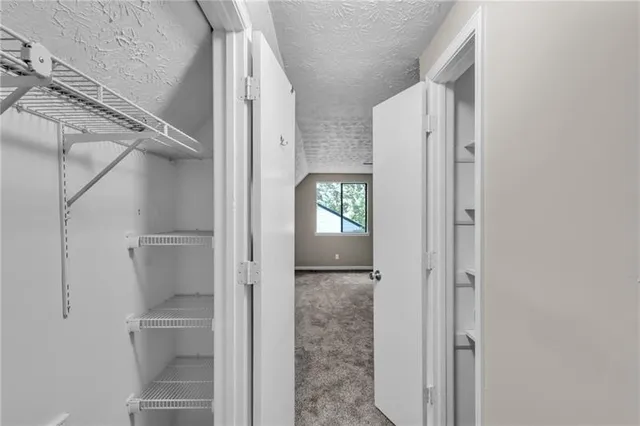 a bathroom with a glass shower door and a sink