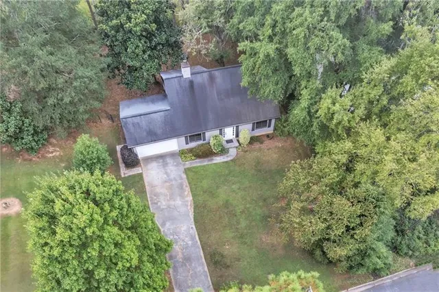 an aerial view of a house with a yard